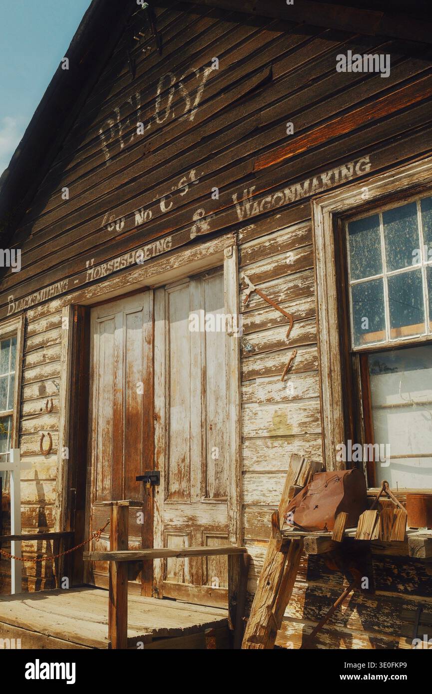 Storico negozio di fabbri in legno con pubblicità sbiadita sulla facciata di Virginia City, Nevada, Stati Uniti Foto Stock