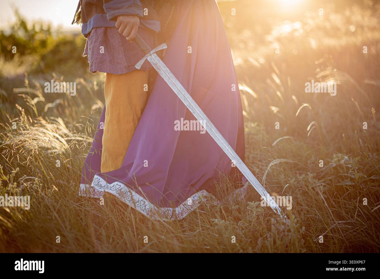 Una donna e un uomo con una spada in costume medievale. Foto Stock