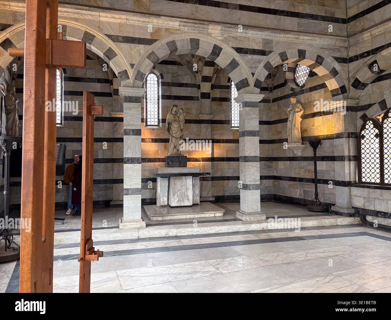 Chiesa di Santa Maria della spina. Pisa, Italia. Interno gotico con rivestimento in marmo bianco e nero e statua della Madonna. I turisti osservano. Foto Stock