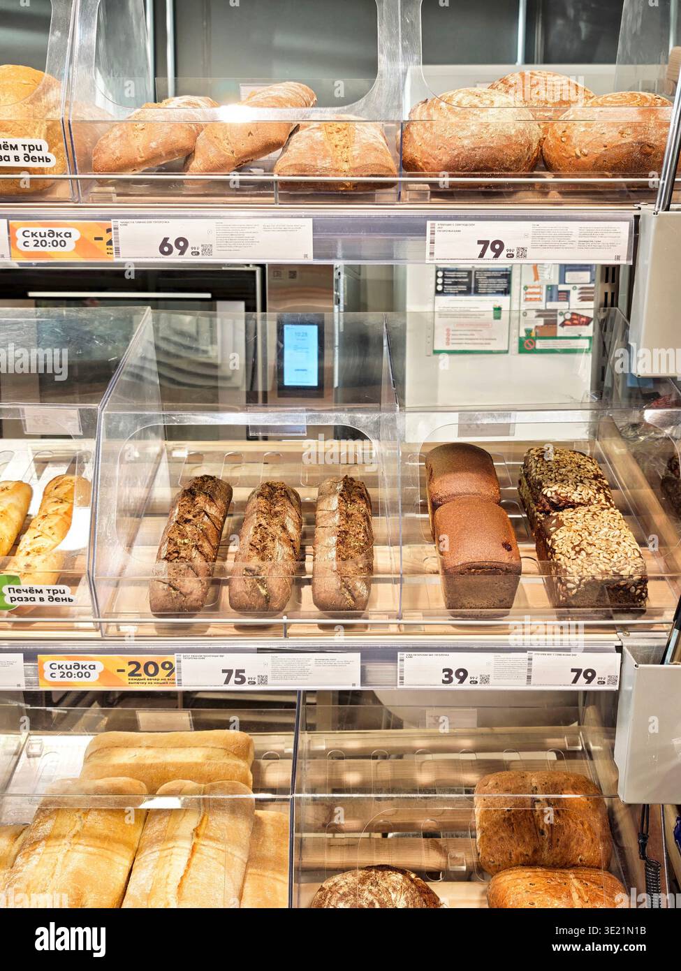 Kirov, Russia - 14 dicembre 2025: Gli articoli da forno sono ordinatamente disposti sugli scaffali di un negozio di alimentari. Sono disponibili diversi tipi di pane e panini Foto Stock