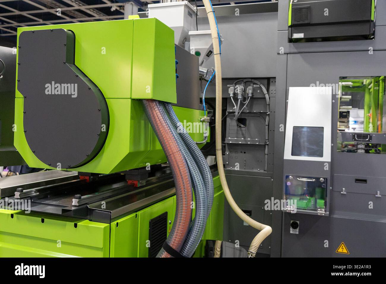 Una foto dettagliata e ravvicinata cattura gli intricati lavori di una macchina industriale automatizzata, prevalentemente colorata in una vivace tonalità verde lime. L'i Foto Stock