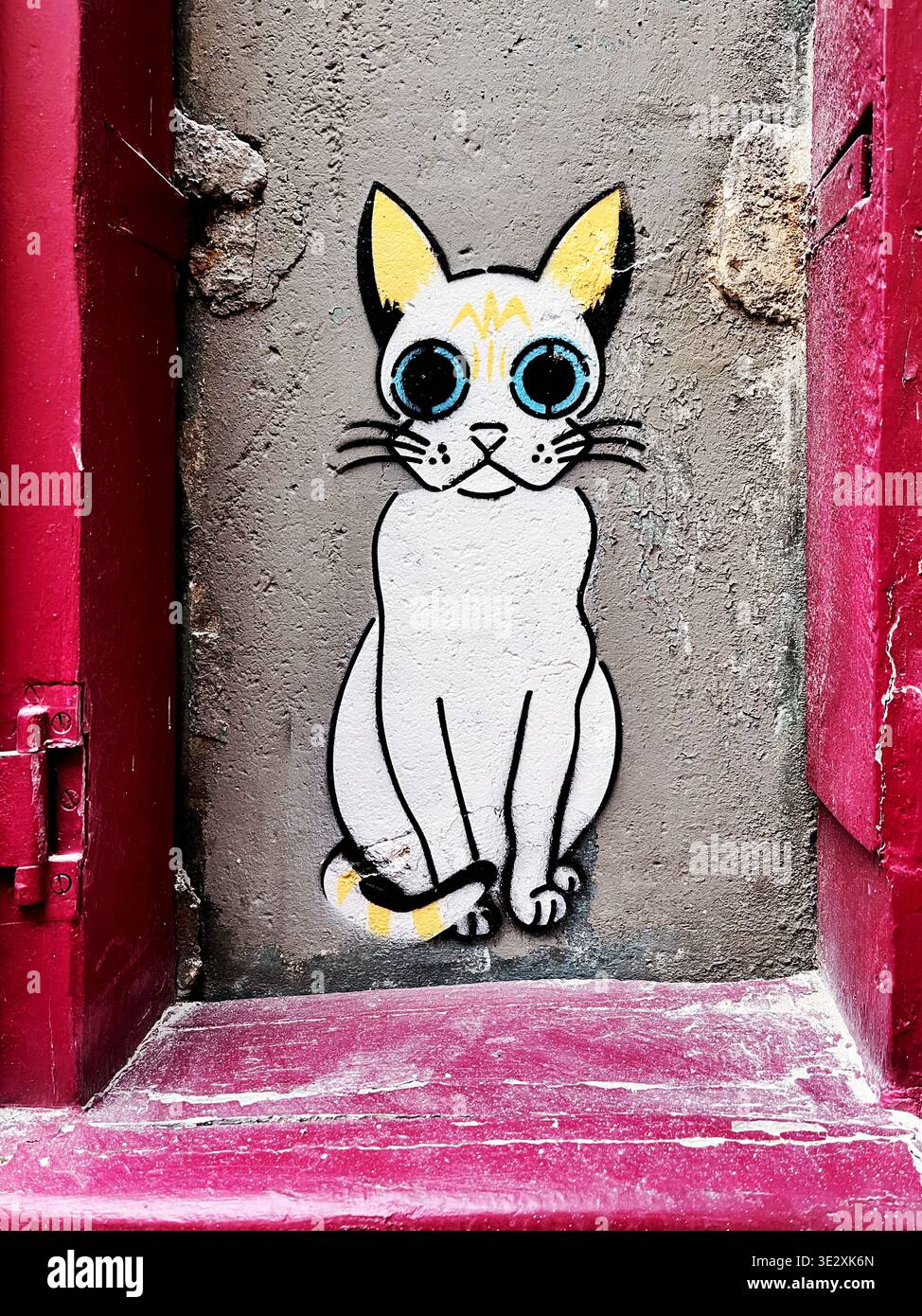 Gatto di verniciatura a spruzzo su un muro di un edificio di Montmartre - Parigi - Francia - Immagine stock catturata con smartphone