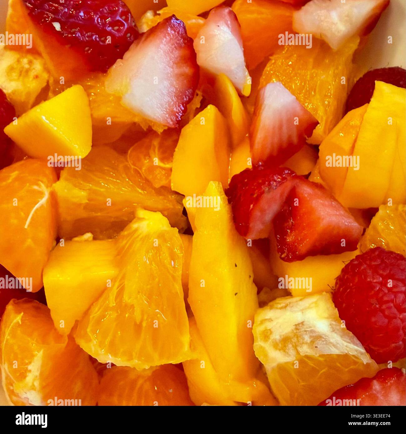 Arance, fragole e mango formano un'insalata di frutta dai colori vivaci. Foto Stock