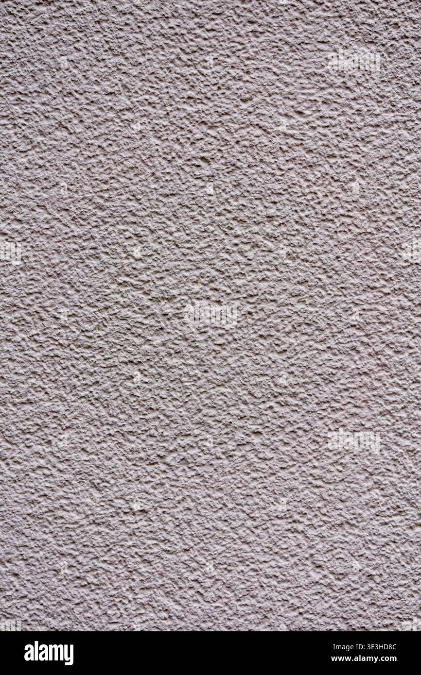 Primo piano di una parete in stucco beige chiaro con grana fine e superficie ruvida. Foto Stock