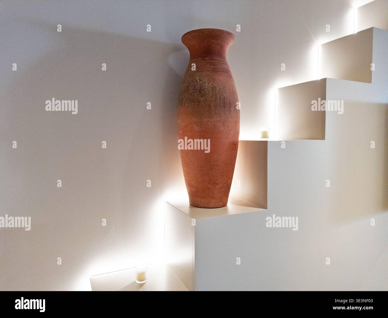 Un biew di natura morta di un grande vaso di argilla situato su una serie di piccoli gradini. Foto Stock