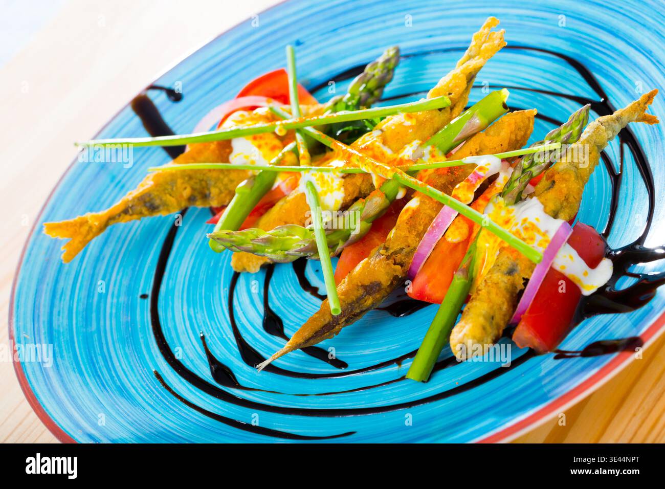 Acciughe in pastella con salsa e verdure Foto Stock