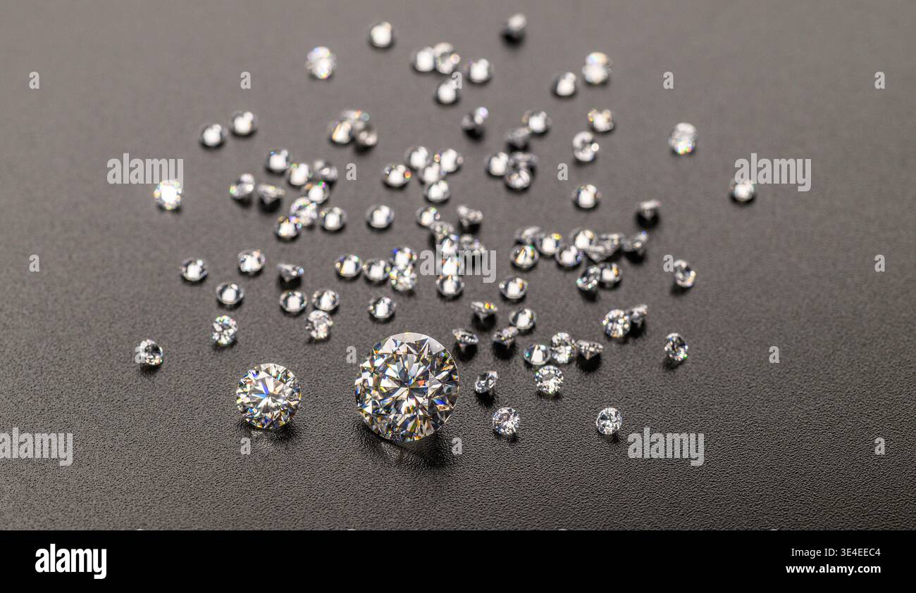 Piccoli diamanti sparsi su una superficie scura e ruvida. Un diamante brilla in modo prominente al centro. Perfetto per gioielli, lusso o idee pubblicitarie. M Foto Stock