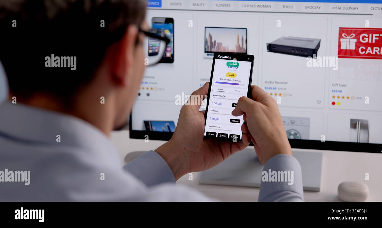 Uomo ispanico interagire con l'app Mobile Loyalty Rewards, guadagnare punti e sconti online Foto Stock
