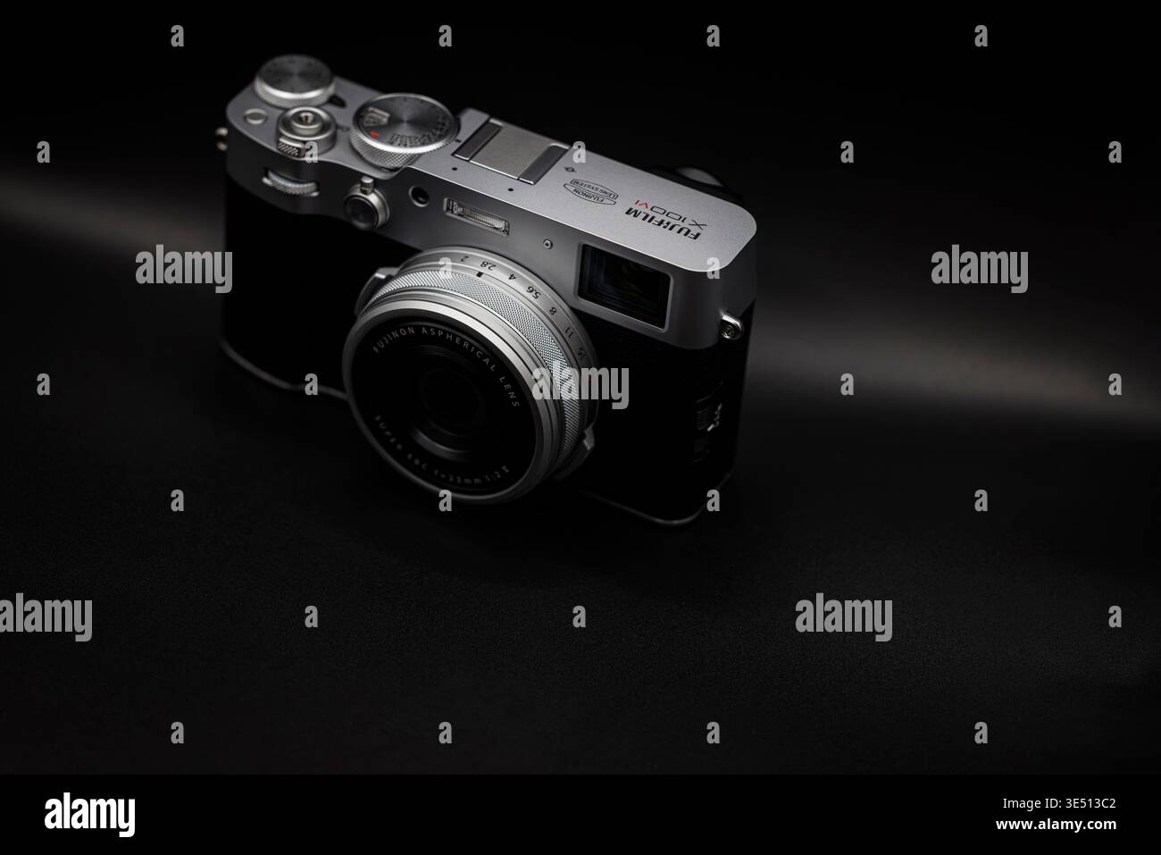 OURENSE, SPAGNA - 25 MARZO 2026: Primo piano della fotocamera Fujifilm X100VI su sfondo scuro con illuminazione soffusa. Composizione minimalista che mette in risalto il desiderio Foto Stock