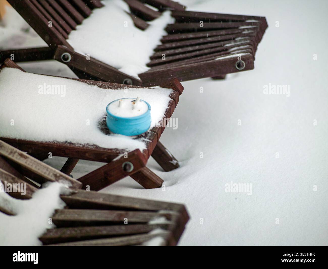un posacenere ricoperto di neve e un paio di poltrone in legno, scene invernali Foto Stock
