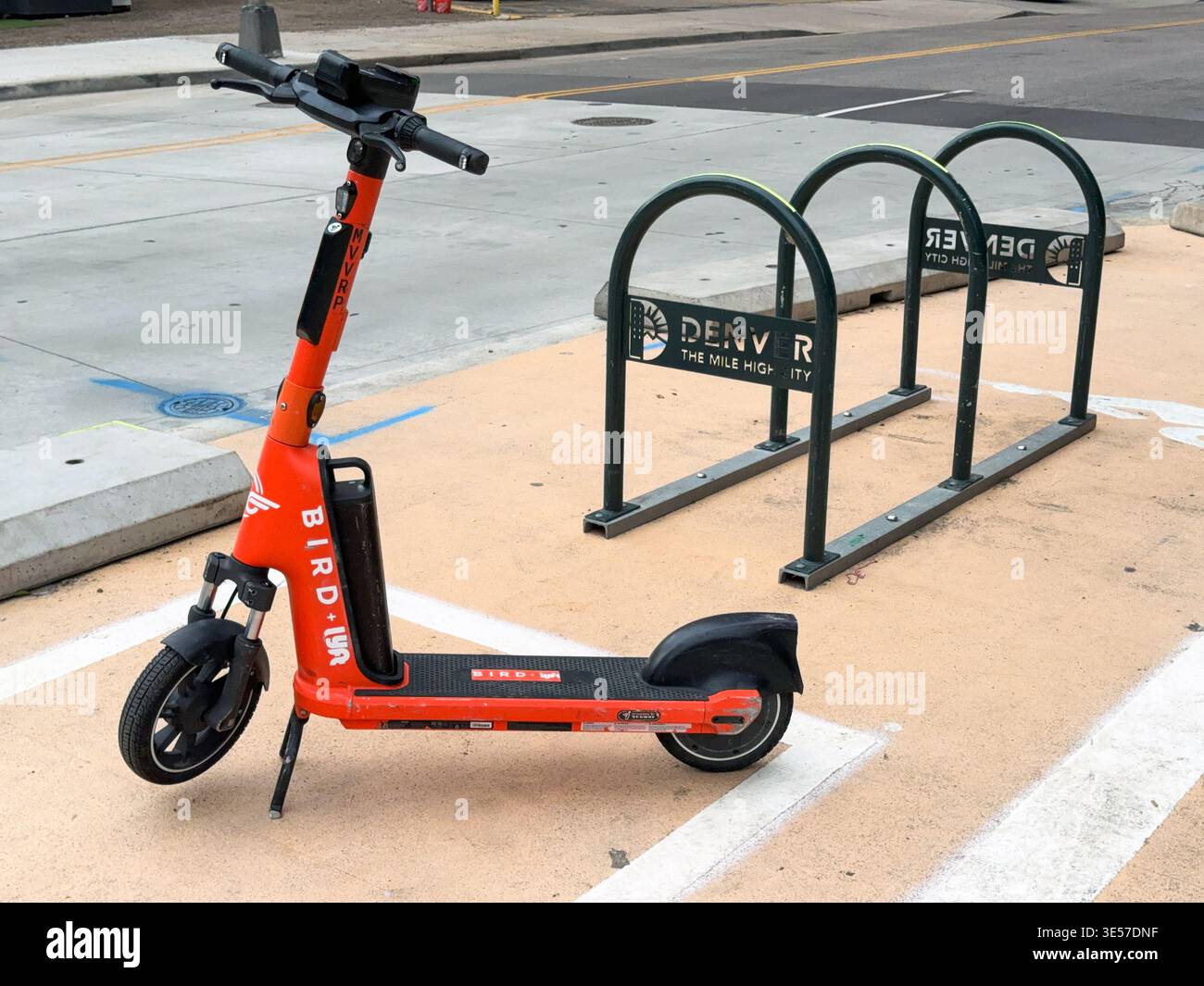 Denver, Colorado, USA - 4 giugno 2025: Scooter elettrico del sistema di condivisione degli uccelli lasciato incustodito su un marciapiede nel centro di Denver. - Immagine stock catturata con smartphone