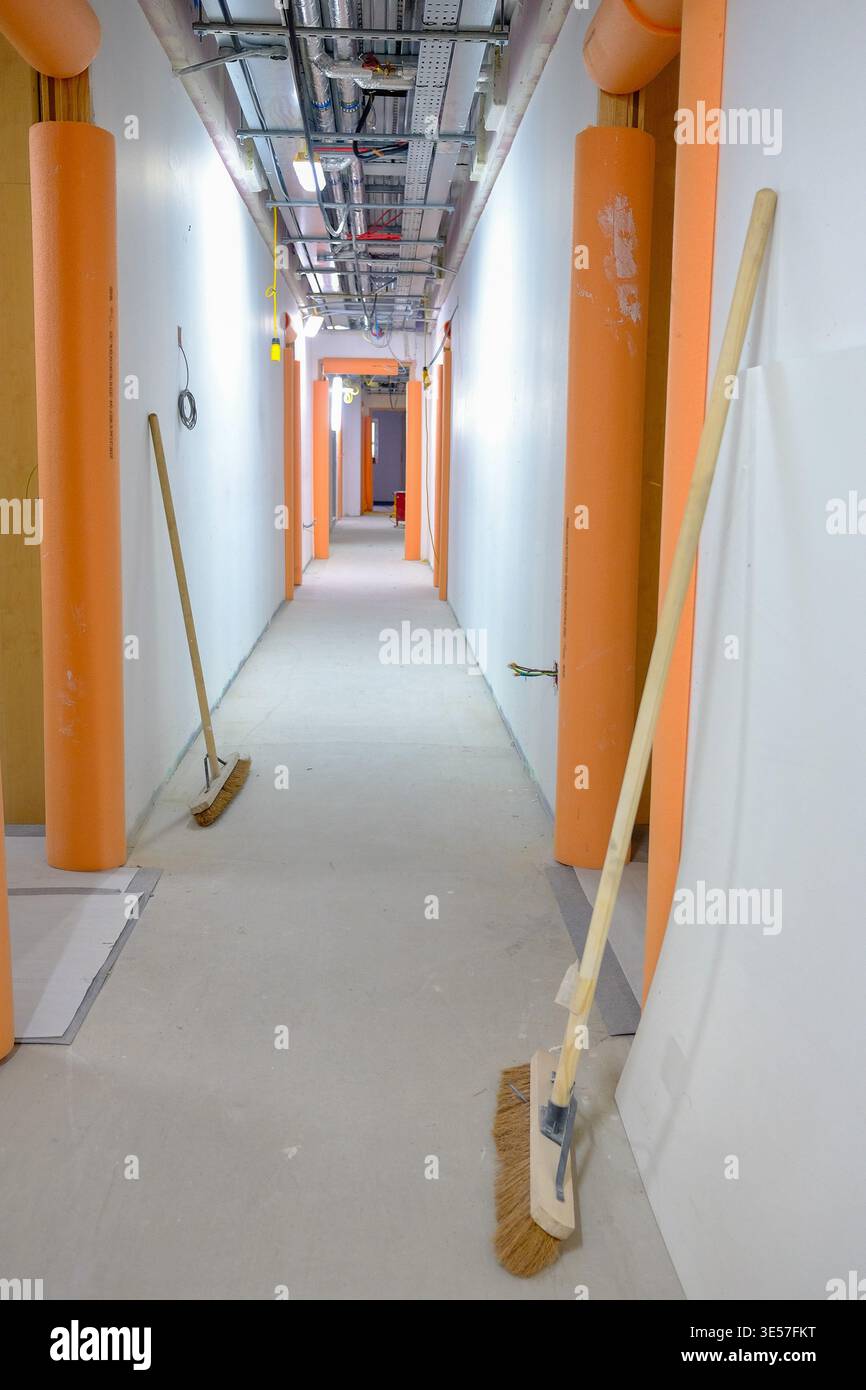 Marzo 2021 - corridoio di un progetto di costruzione quasi completato mostra la protezione del telaio della porta e le spazzole con il soffitto ancora aperto. Foto Stock