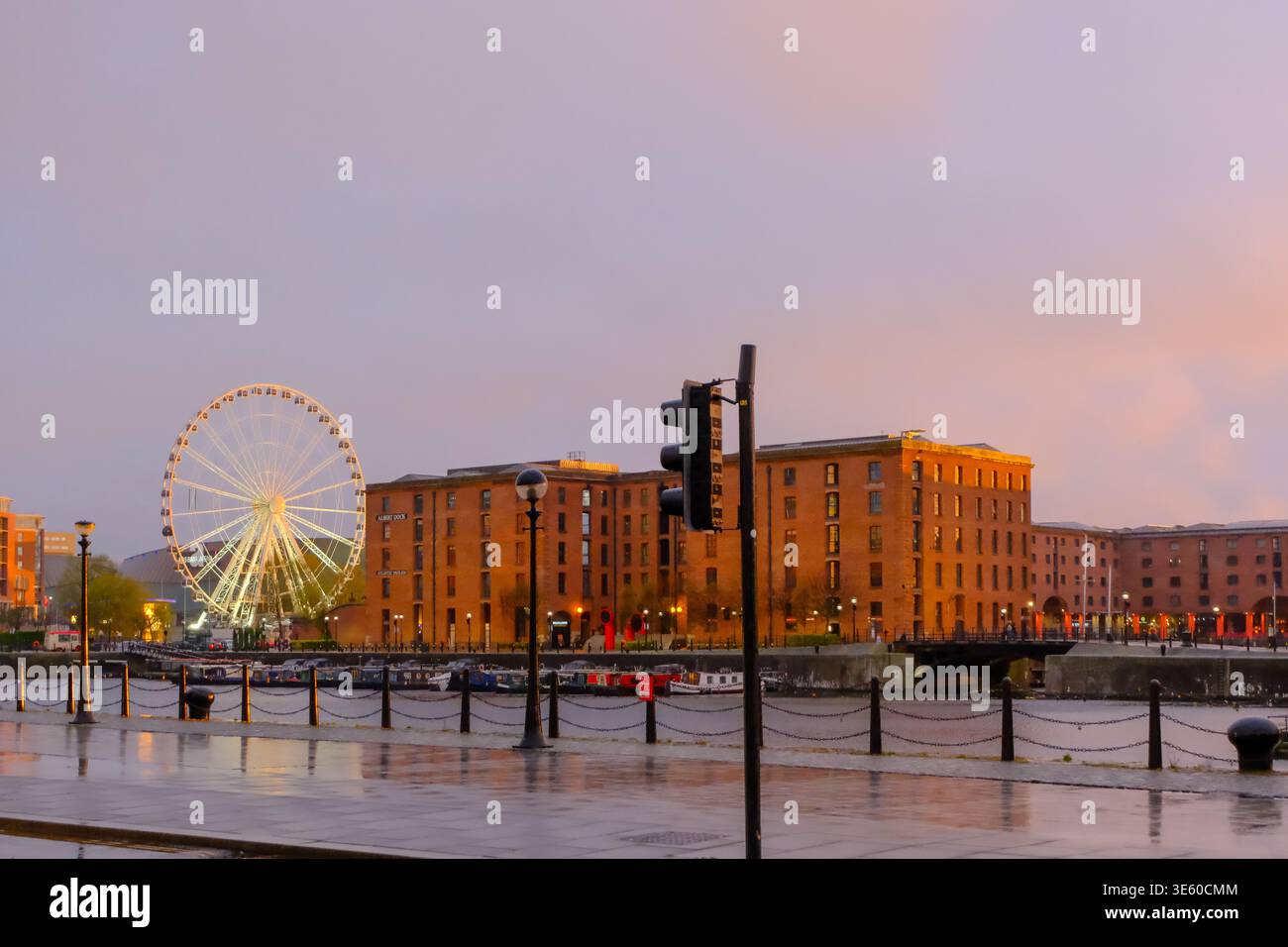 La ruota di Liverpool e gli edifici Royal Albert Docks sul lungomare di Liverpool al tramonto. Foto Stock