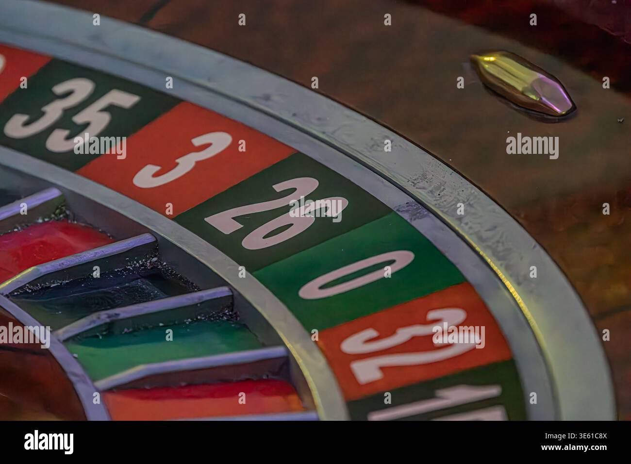 Vista ravvicinata di una roulette illuminata con fessure numerate rosse e nere alternate prospettiva dall'alto, nessun contesto o abbellimento aggiuntivo Foto Stock