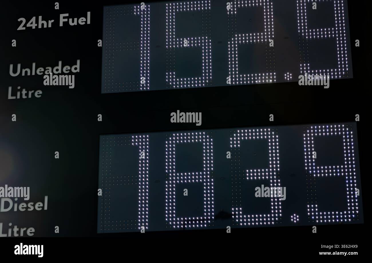 Un primo piano della scheda digitale della stazione di servizio che mostra i prezzi del carburante diesel e senza piombo. Foto Stock
