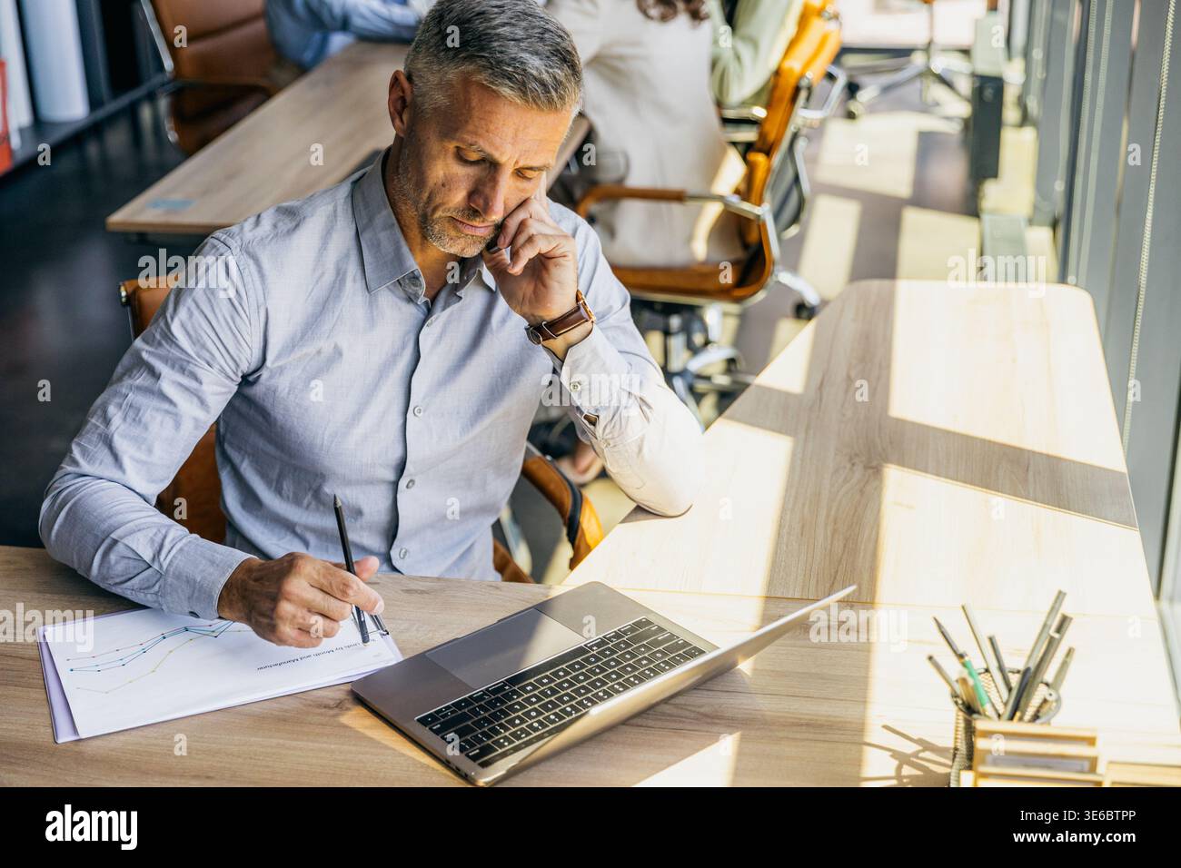 Consulente legale professionale che esamina attentamente i dettagli del contratto Foto Stock