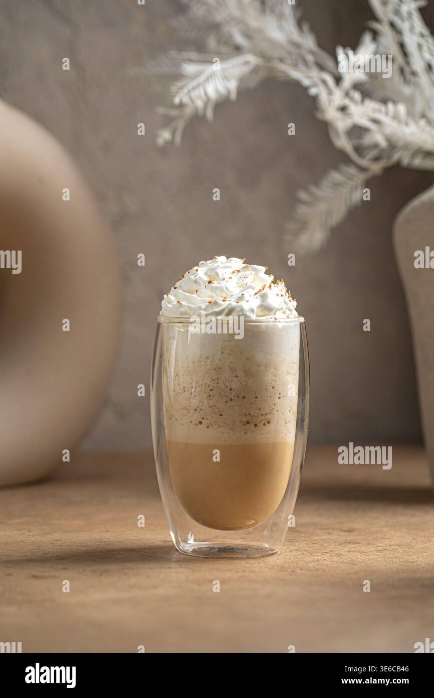 Bevanda al caffè con panna montata in una tazza di vetro Foto Stock