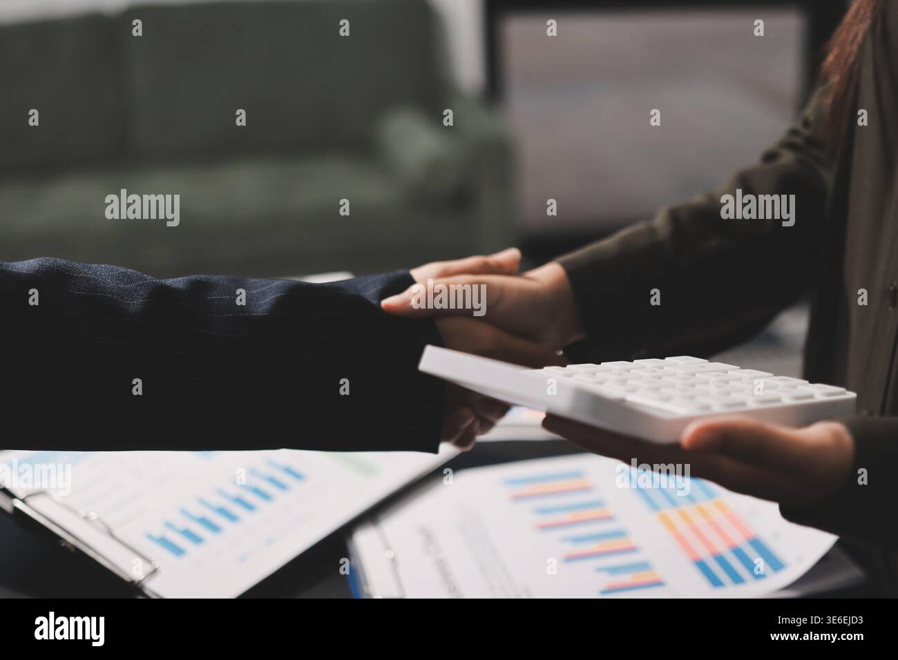 I giovani uomini d'affari scuotono le mani in ufficio. Conclusione di una riunione di successo. Tre persone. Schermo panoramico Foto Stock