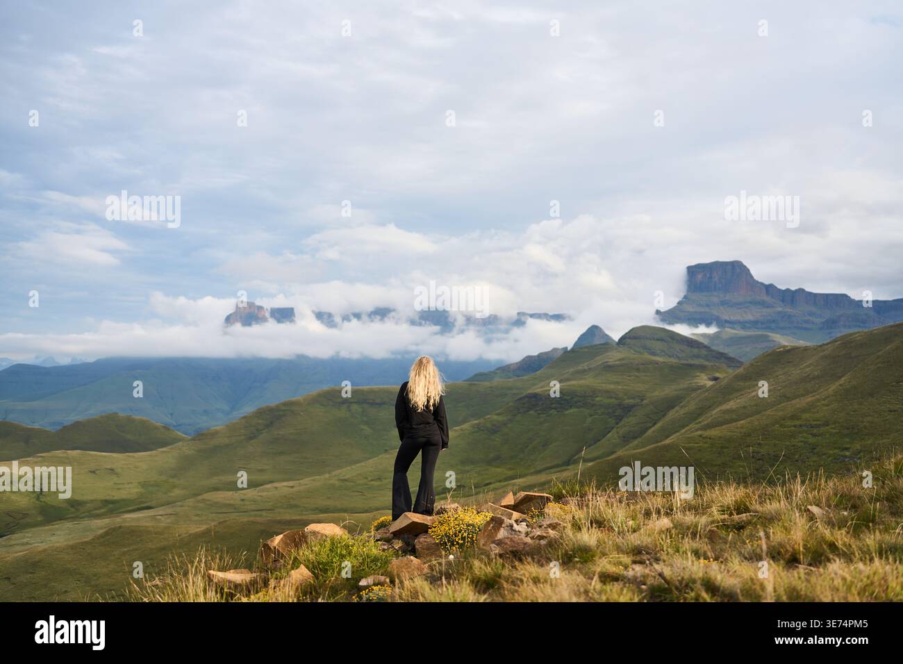 Ammira le Green Peaks. Solitary Traveler si trova in cima al Grassy Ridge, con montagne torreggianti lontane Foto Stock
