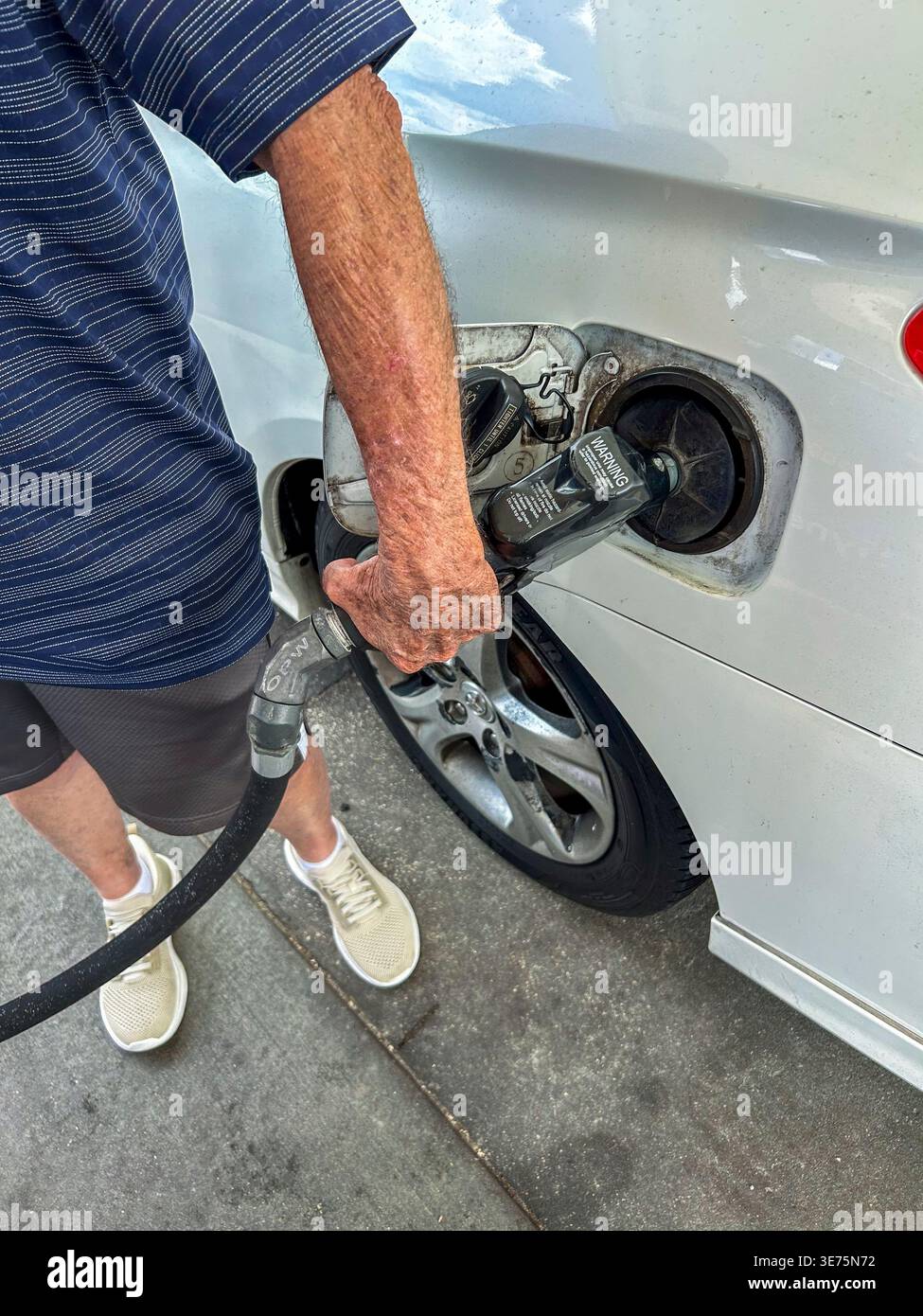 Venice, Florida, USA, primo piano, Man Pumping gas to Car presso la stazione di servizio locale americana, Mobil Oil CO Foto Stock
