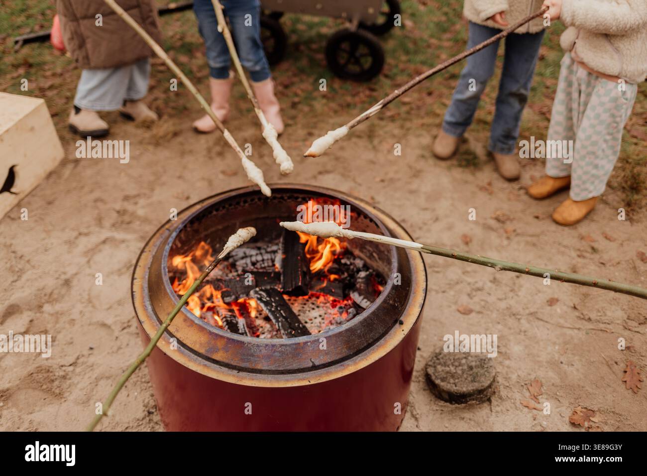 Impasto di pane arrostito su bastoncini sopra il fuoco aperto all'aperto Foto Stock
