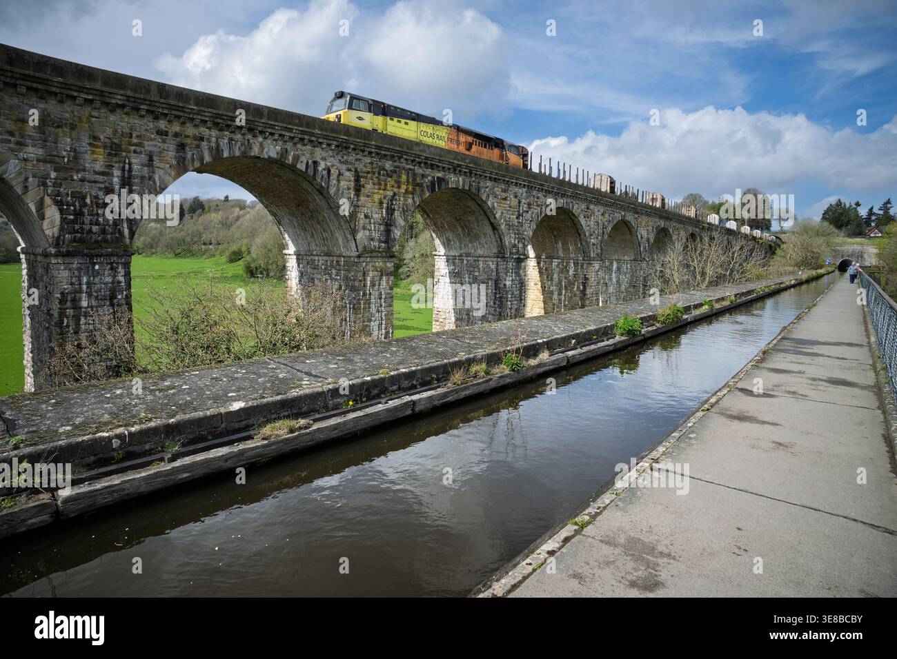 Una locomotiva diesel di Colas Raailfreight trainata da un treno di vagoni vuoti attraversa il viadotto Chirk accanto all'acquedotto del canale Llangollen nel Galles del Nord Foto Stock