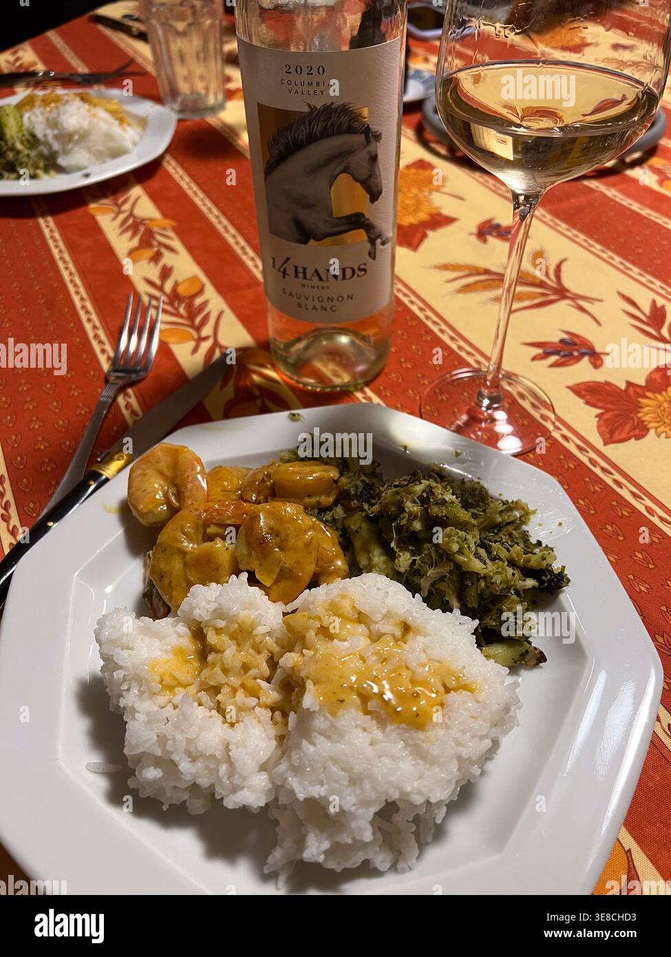 Berkeley Heights, New Jersey, USA - 02-10-2022: Bottiglia di vino bianco dello stato di Washington servita con gamberetti, riso e broccoli - Immagine stock catturata con smartphone