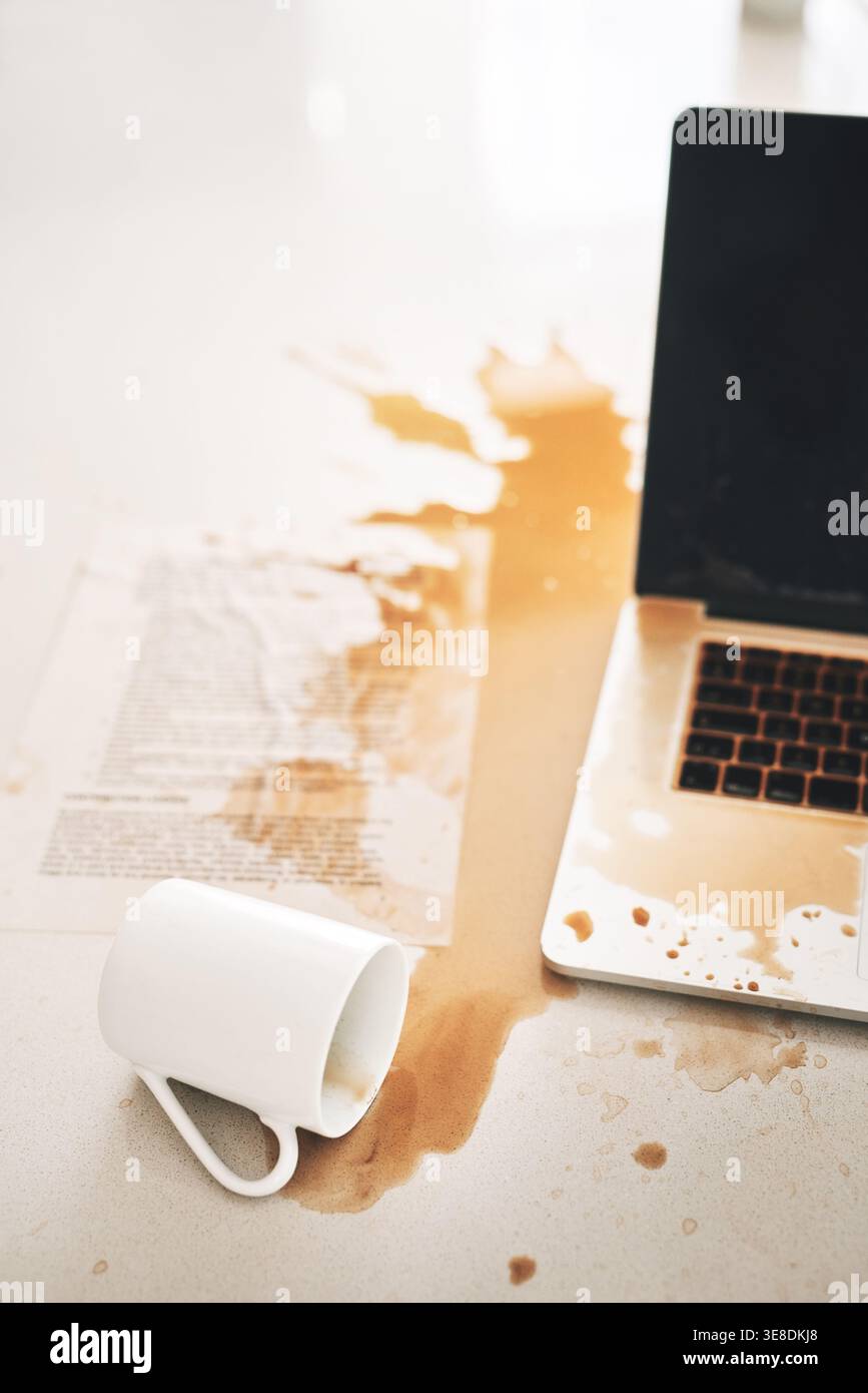 Laptop, caffè e fuoriuscite con errori, disastri e incidenti d'ufficio con documenti. Splash di tastiera, caos e crisi dei computer con tecnologia, disordine e.. Foto Stock