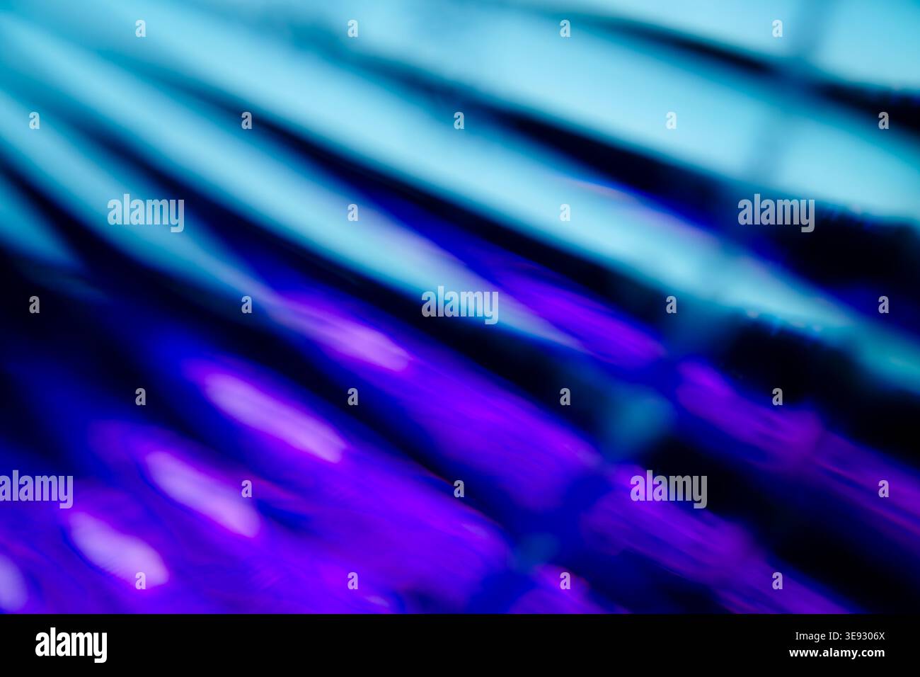 Macro astratta di rifrazione in vetro blu e viola con linee diagonali Foto Stock