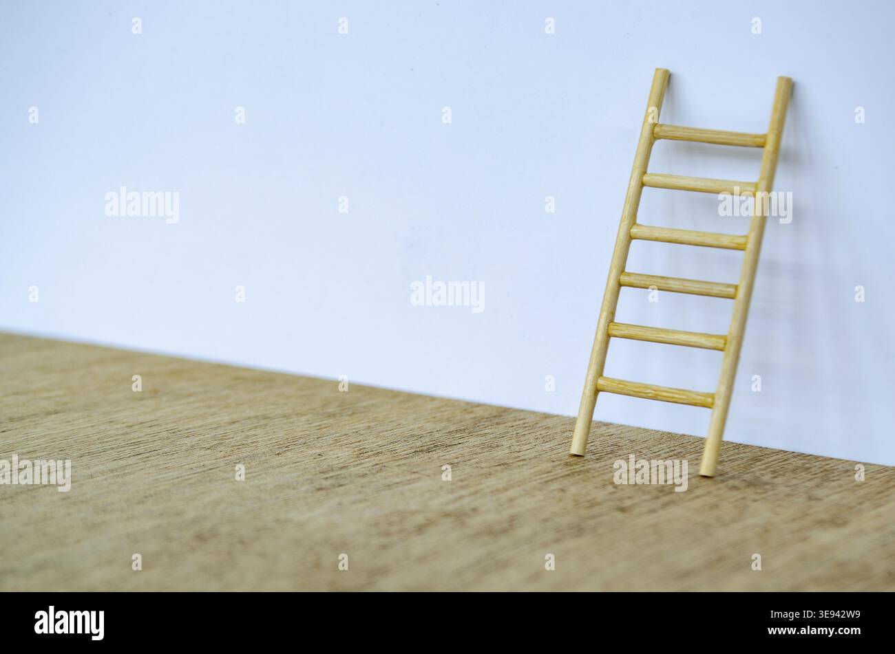Scala in legno in piedi su un coperchio bianco con spazio personalizzabile per testo o idee Foto Stock