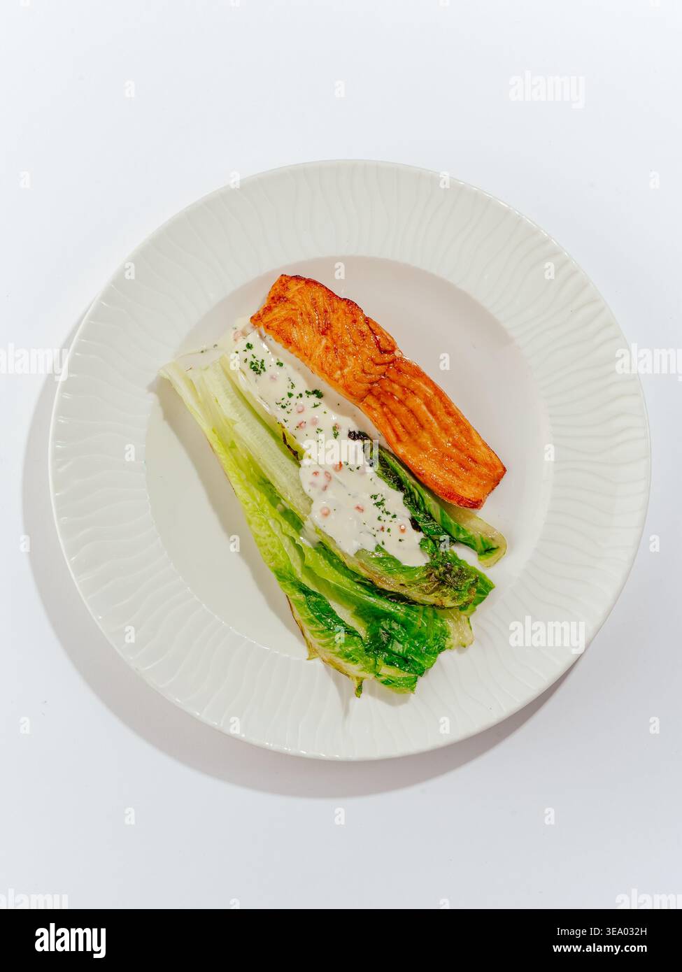 salmone alla griglia con salsa e verdure su un piatto Foto Stock