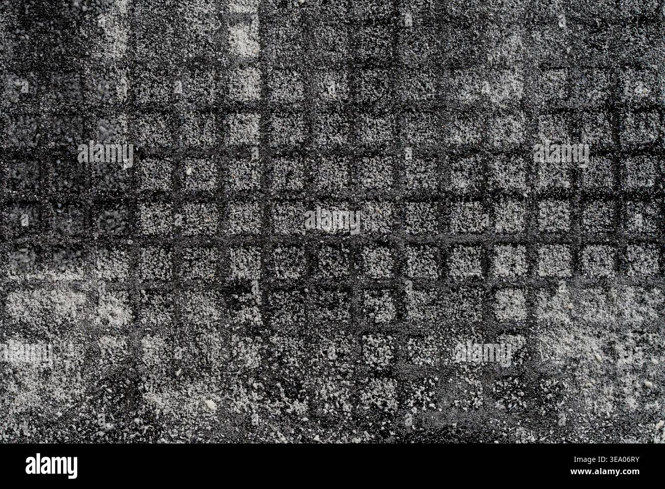 Vista macro di un contenitore di conservazione in plastica nera coperto da cristalli di ghiaccio bianchi dopo essere stato rimosso dal congelatore. Temperatura fredda e testo congelato Foto Stock