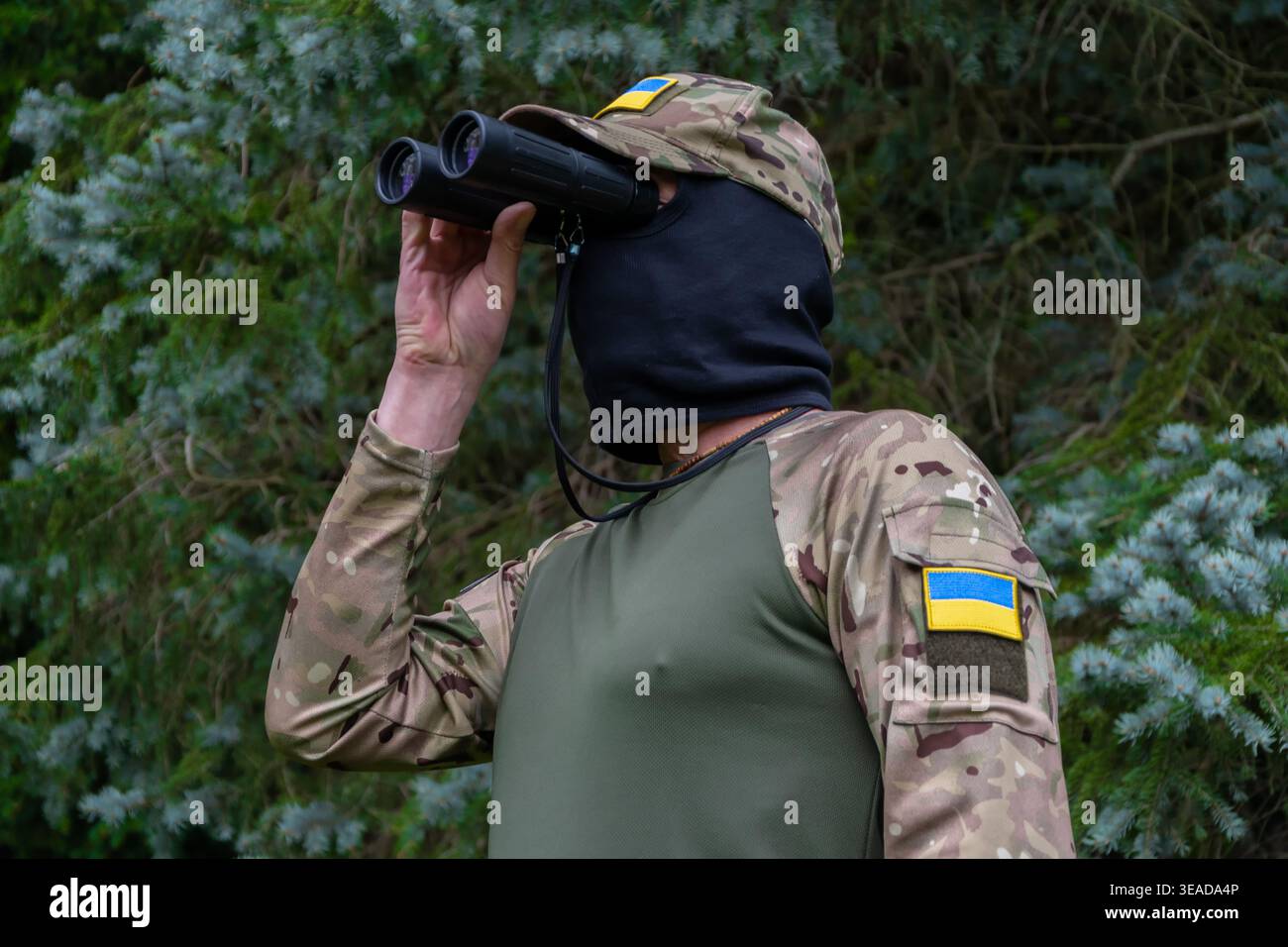 Scout militare con binocoli e patch di bandiera Ucraina. Foto Stock