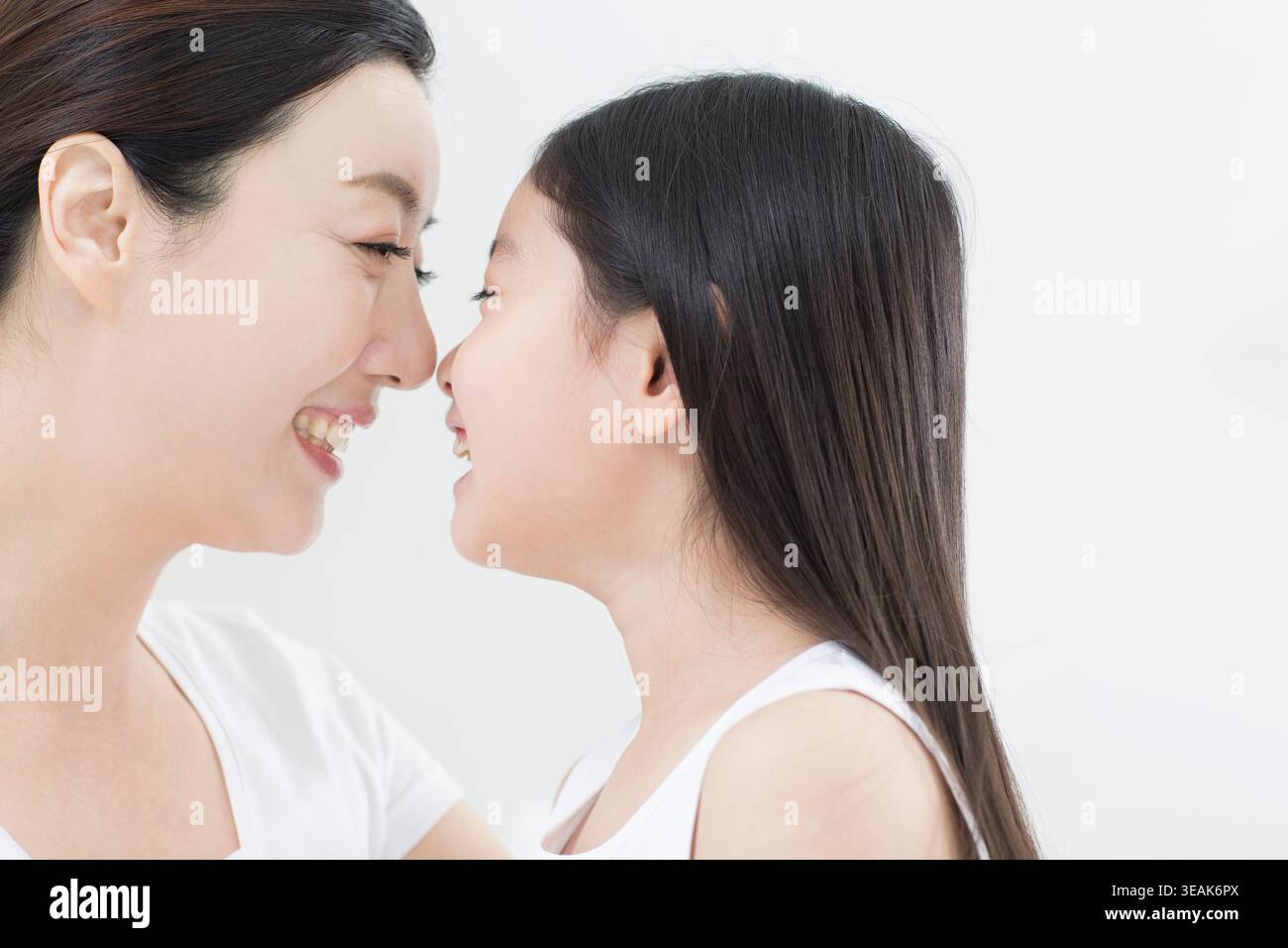 Vista laterale ritratto di sorridente madre e figlia faccia a faccia Foto Stock