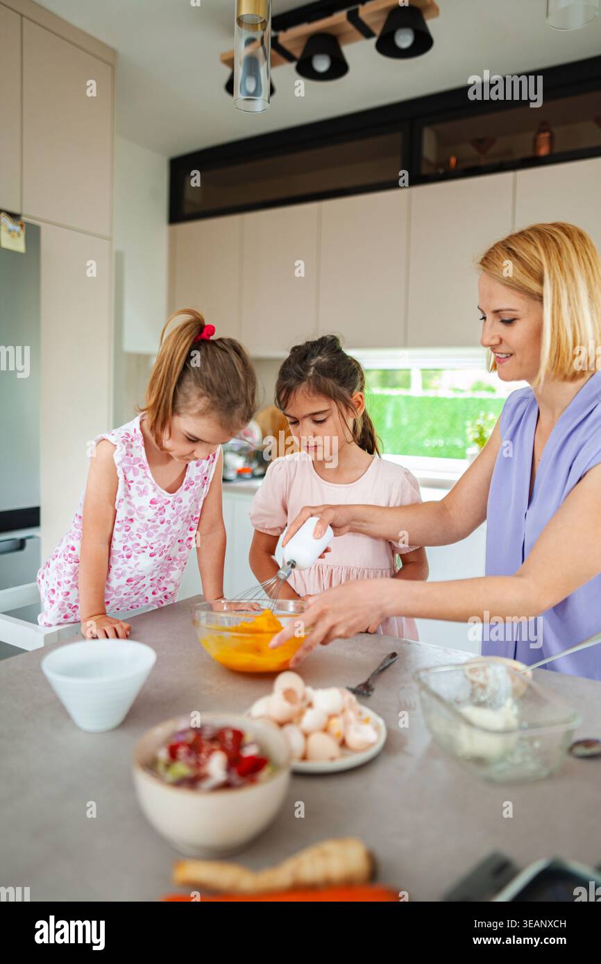 Cucinare insieme crea ricordi gioiosi in cucina Foto Stock