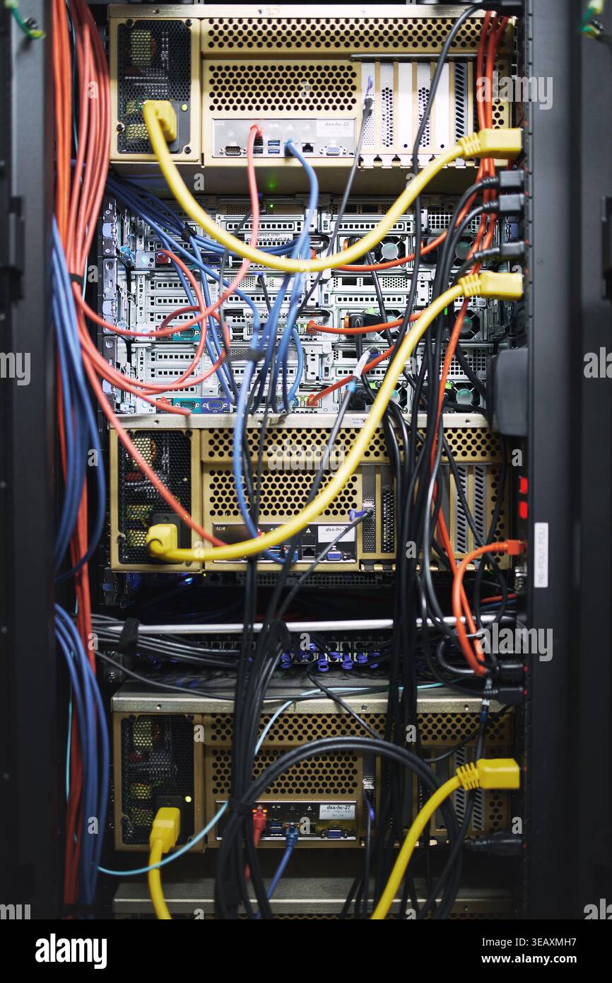 Rack, cablaggio e apparecchiature informatiche nella sala server per l'archiviazione di database, la sicurezza informatica o l'hardware. Sistema IT, primo piano e cavi nel data center per Foto Stock
