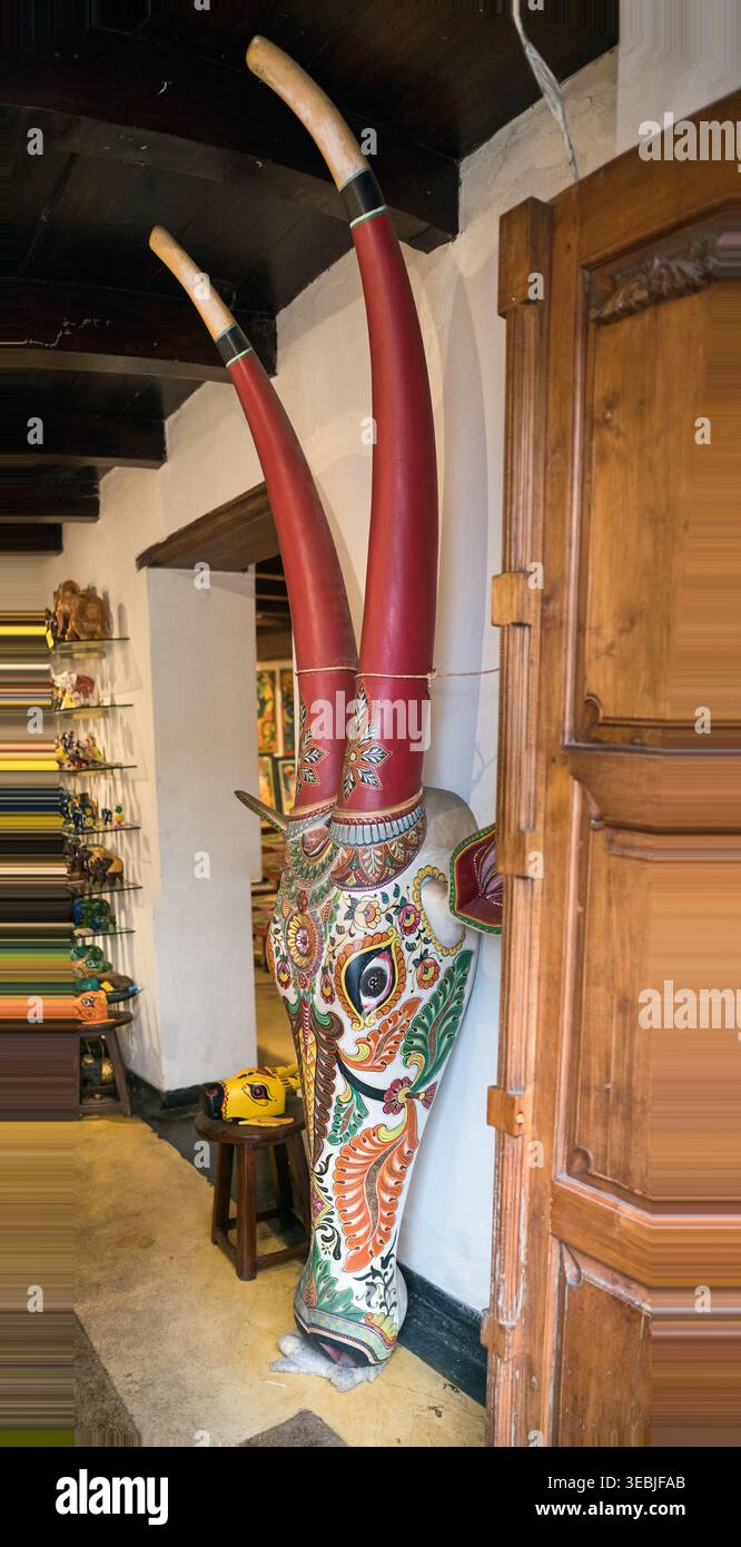 Colorato intaglio della testa di una mucca in un negozio di curiosità a Jew Town a Cochin Foto Stock