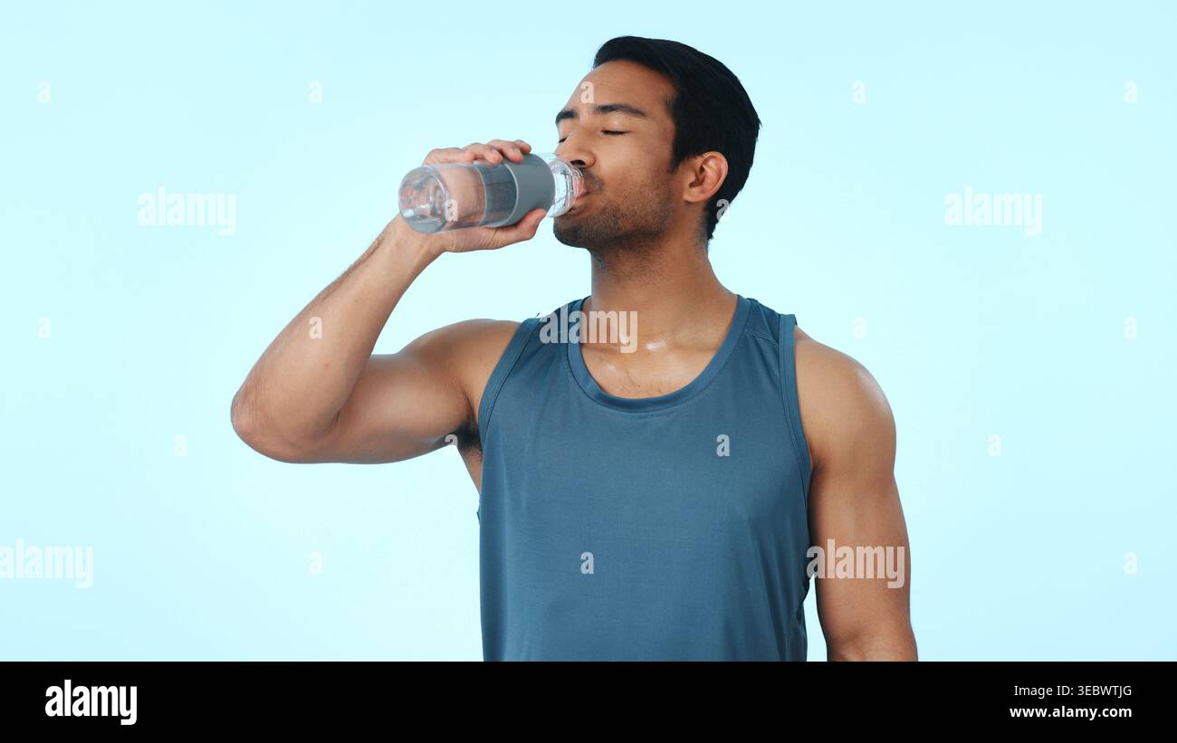 Esercizio fisico, bere e uomo con acqua in studio per idratazione, elettroliti e acqua per il fitness. Personal trainer, spazio e persona con minerali per Foto Stock