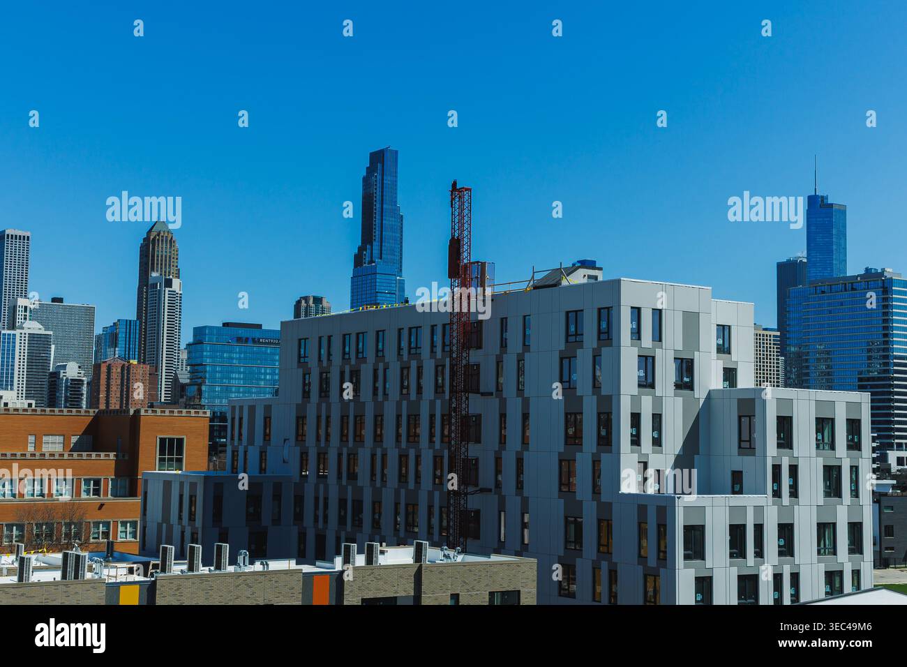 Alti edifici sorgono nel centro di Chicago in una giornata limpida. Un cantiere è visibile vicino al bordo della vista. Lo skyline mostra varie architetture Foto Stock