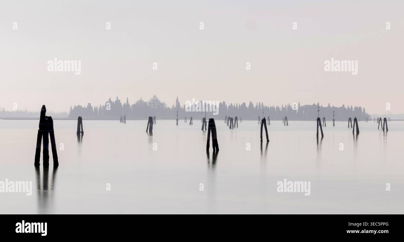 Laguna di Venezia, Italia, tradizionali briccole in legno che si innalzano dall'acqua, segnando i canali di navigazione attraverso la storica laguna veneziana. Foto Stock