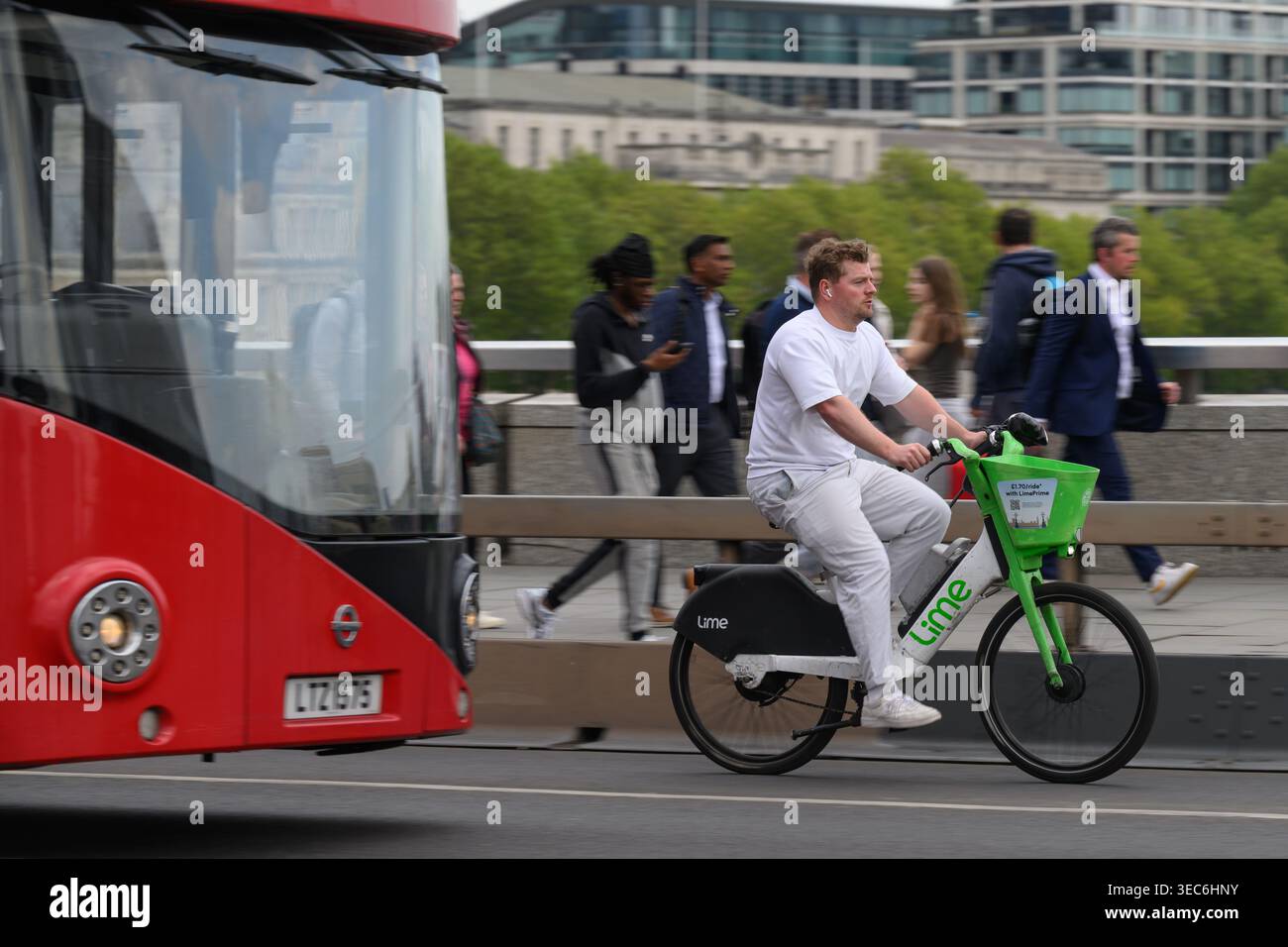 Un uomo che viaggia su una bicicletta elettrica Lime attraverso il London Bridge durante l'ora di punta serale. London Bridge, Londra, Regno Unito. 27 aprile 2026 Foto Stock
