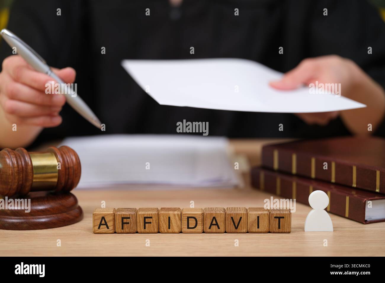 Documenti legali e un martelletto su una scrivania durante una seria consultazione nell'ufficio di un avvocato Foto Stock