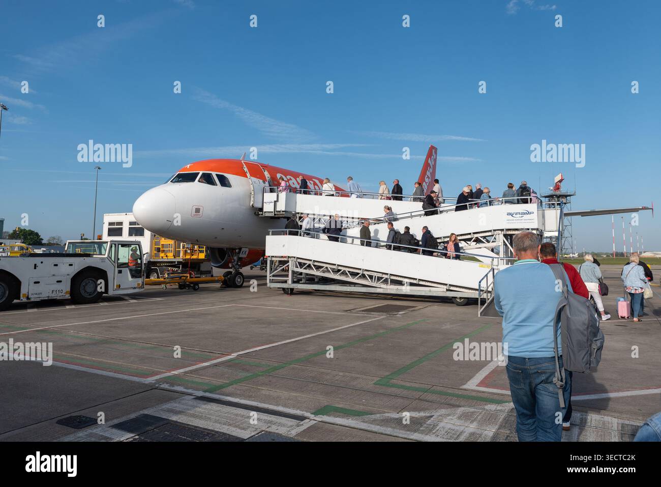 EasyJet Airbus A319 aereo di linea a terra all'aeroporto Southend di Londra per un volo per la Spagna. Imbarco dei passeggeri utilizzando la rampa senza gradini Foto Stock