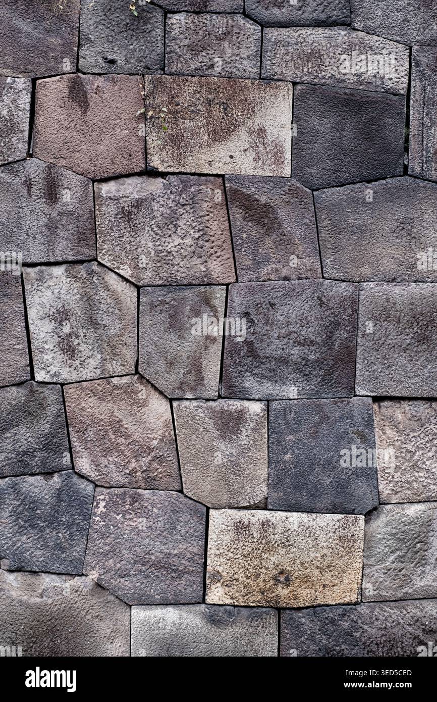 Le pietre su una parete tradizionale giapponese sono impilate insieme in uno schema stretto per formare un muro strutturalmente stabile. Foto Stock