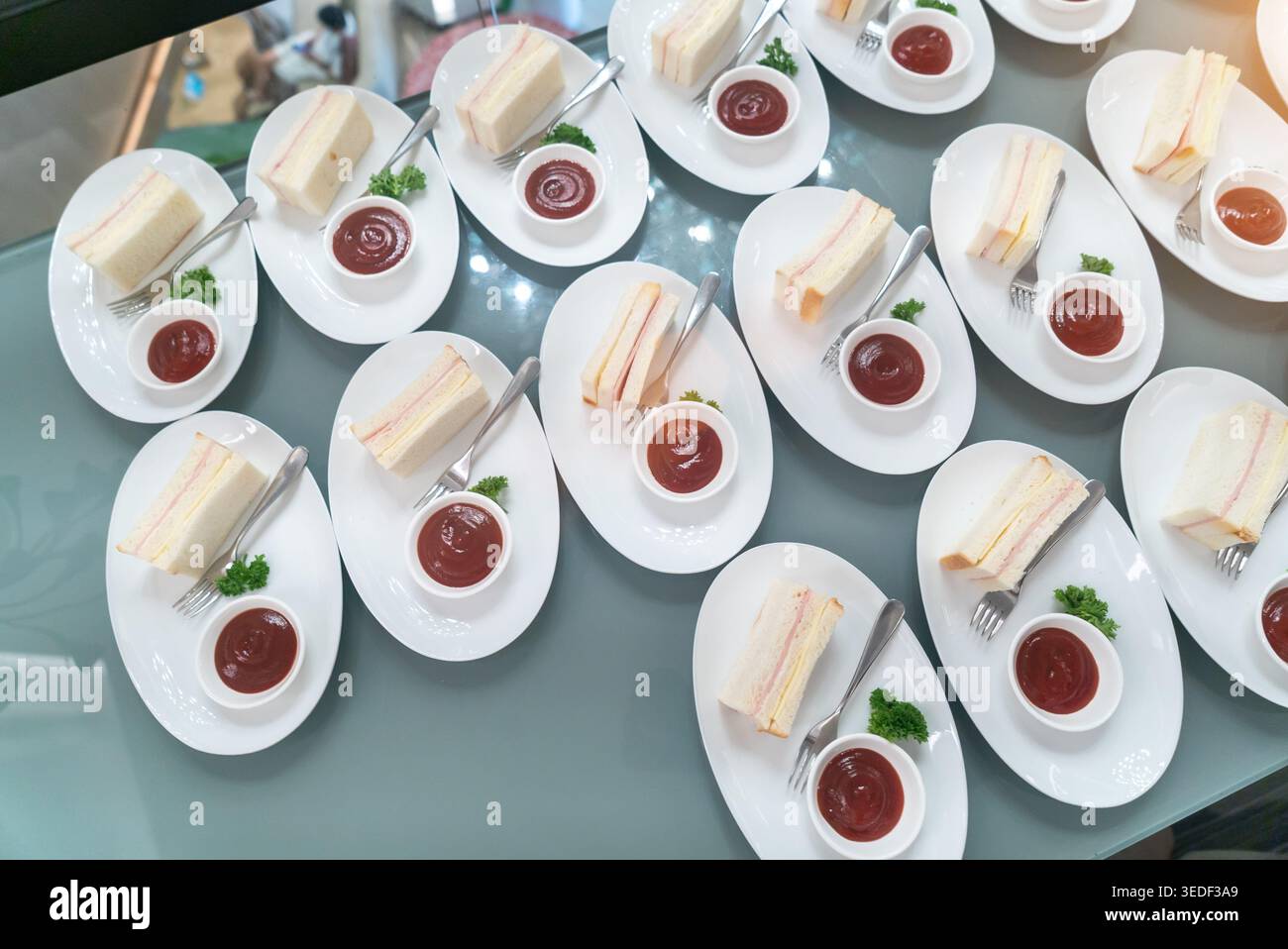 Un delizioso assortimento di fette di torta abbinate alla salsa su eleganti piatti bianchi, perfetto per eventi di catering, feste o menu di dessert. Foto Stock