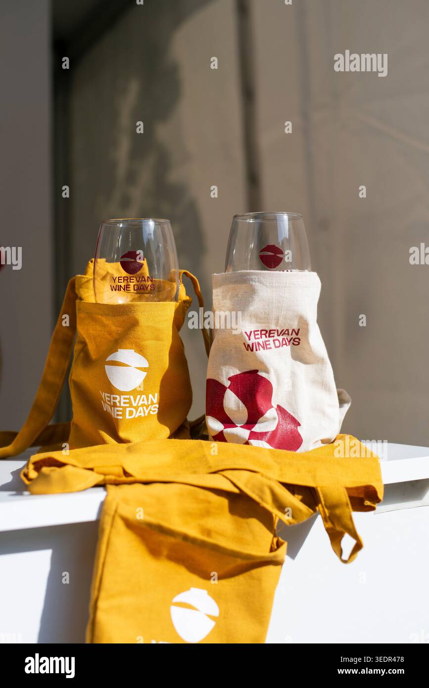 Al Festival del vino di Yerevan, i bicchieri da vino sono collocati all'interno di sacchetti riutilizzabili in mostra presso uno stand del festival. Foto Stock