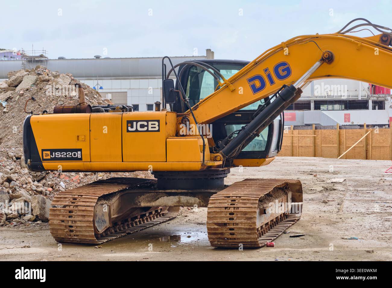 Demolizione di cantieri con escavatore giallo JCB e accumuli di detriti nella città vecchia di Gibilterra Foto Stock
