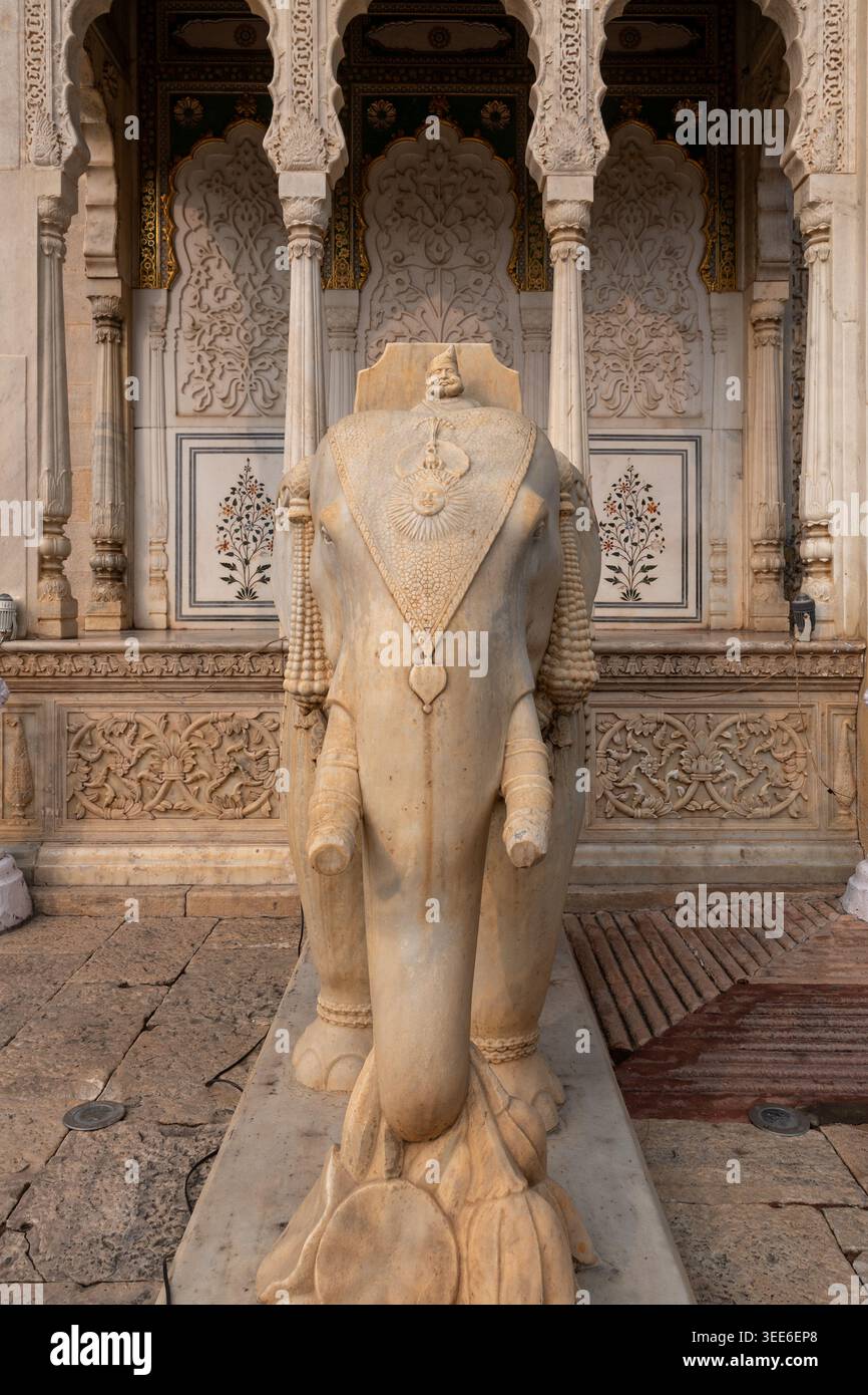 Grande statua in marmo di una figura reale prima del santuario ornato ad arco in pietra dura, Palazzo della città, Jaipur, Rajasthan, India Foto Stock