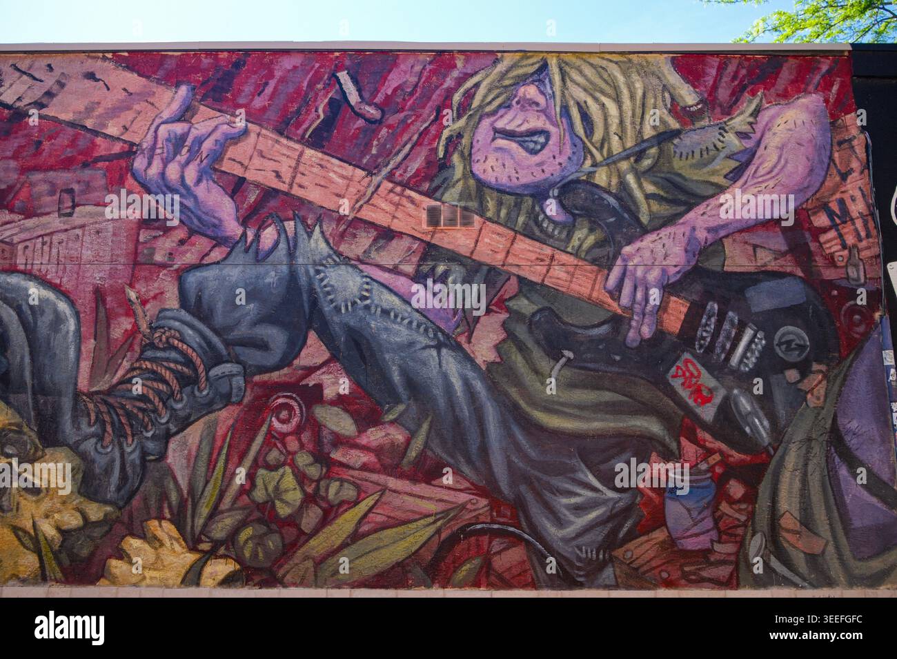 Un murale di chitarra a dondolo dell'artista Bruno Smoky lungo un vicolo nel centro di Kelowna, British Columbia. Foto Stock