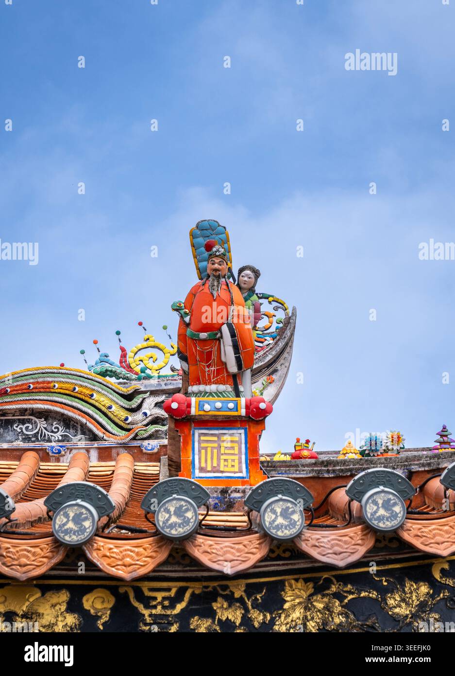 Primo piano del vivace rilievo in porcellana tagliata a Chaozhou che raffigura figure mitologiche e operistiche sul tetto dell'antico tempio di Qinglong, Guangdong, Cina Foto Stock